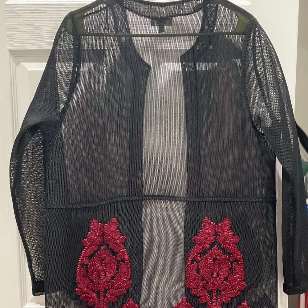 Black mesh duster. Red embroidered design along the bottom